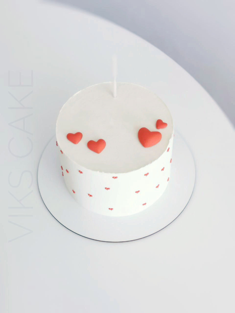 white cake with red hearts